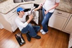 Tom, one of our Auburn plumbing contractors shows the customer the new spray faucet that he will install