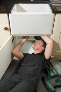 an Auburn plumbing tech installs a new farmhouse style sink